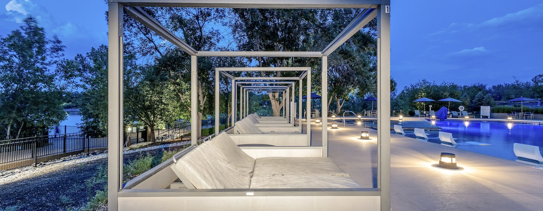 a row of cabanas near a pool