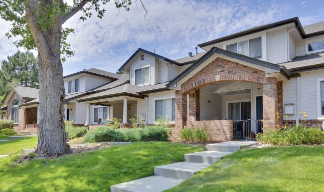 a row of houses with front yards