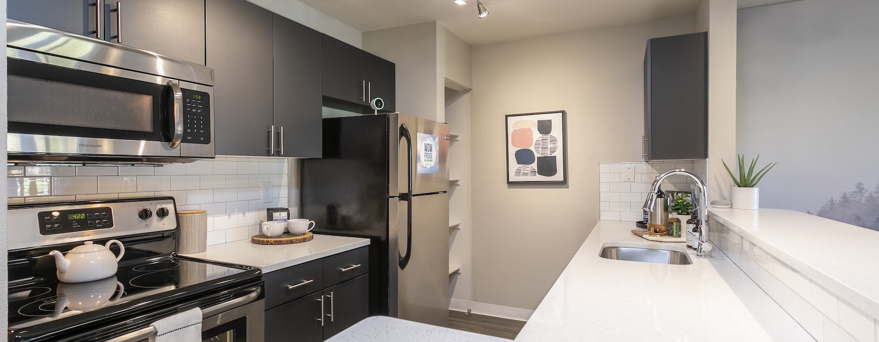 a kitchen with dark cabinets