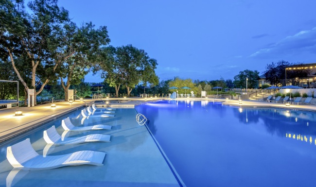 a swimming pool with lounge chairs
