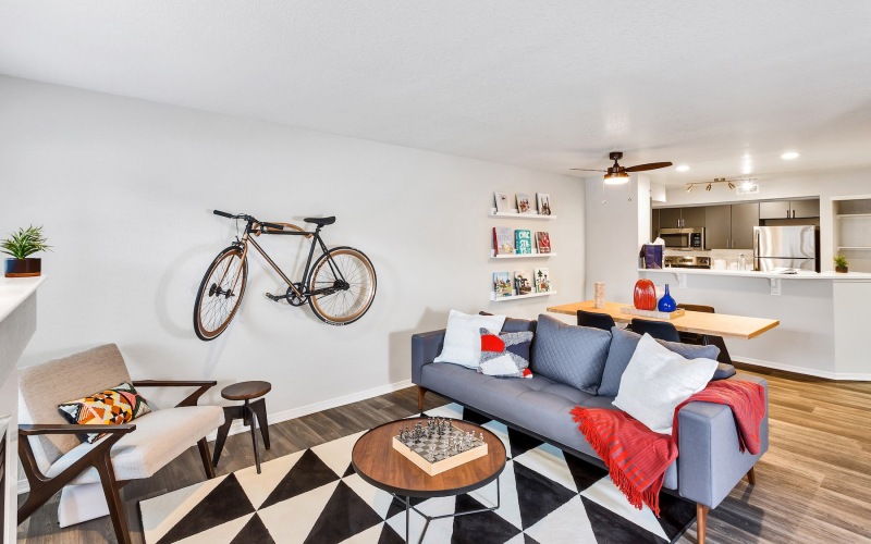 a living room with a couch, chairs and tables