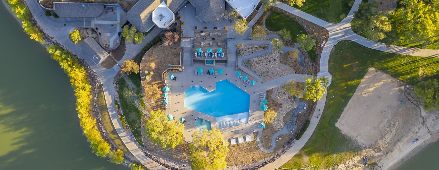 a drop down view of an apartment complex with a pool